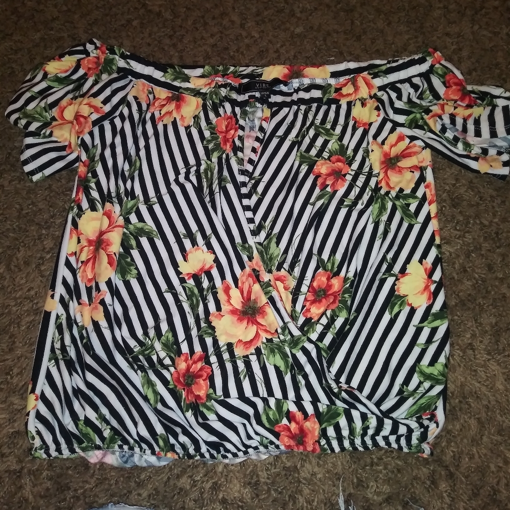 Sliced off shoulder floral blouse.
